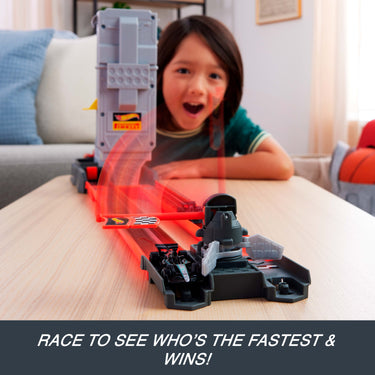 Excited child watching two F1 cars race down the Grid Start track
