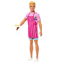 Barbie Mysteries Beach Detectives Ken doll wearing a pink striped apron and holding a snack plate