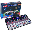 NASA piano dance mat with space-themed keys in front of its box