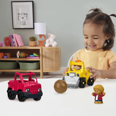 Child playing with the Little People pickup truck, bulldozer and figures at a table