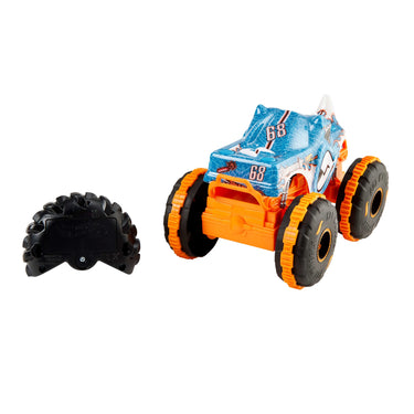 Rear three-quarter view of the Rhinomite RC monster truck with orange wheels and the remote