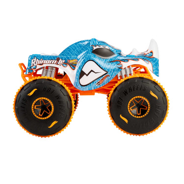 Side profile of the blue Rhinomite RC monster truck with orange Grip Action Tires