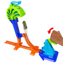 Hand slamming the launcher to send a toy car up toward the green catch cage