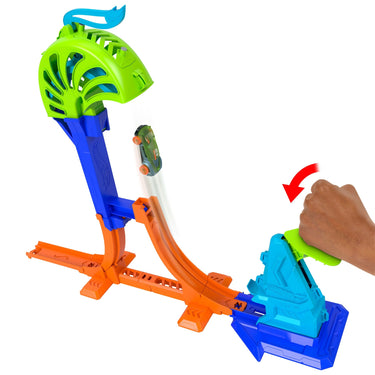 Hand slamming the launcher to send a toy car up toward the green catch cage