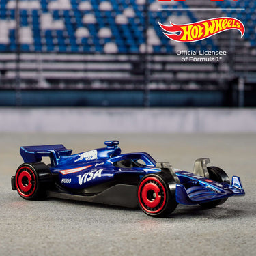 Blue Formula 1 die-cast car with red wheels from the Hot Wheels 5-pack on a racetrack backdrop