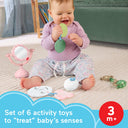 Baby sitting on a rug playing with the Mini Me Moments self-care sensory toys