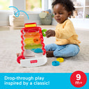 Toddler dropping a ring into the Fisher-Price Drop Through Rock-A-Stack, labeled for ages 9 months and up