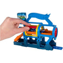 Hand pushing a car through the rollers of the Turbo Jet Car Wash playset