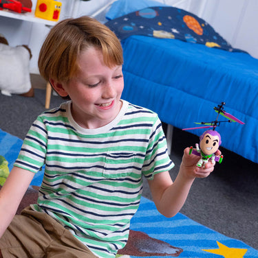 Child flying the Buzz Lightyear helicopter above his hand