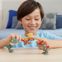 Child playing with three Mighty Little Biters dinosaur figures on a table