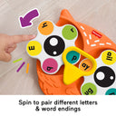 Hand spinning the letter spinners on the Spin 'n Rhyme owl toy