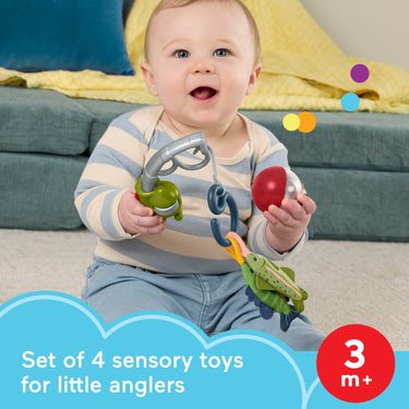 Smiling baby holding the Reel Fun Fishing pole and rattle bobber, labeled set of 4 sensory toys for ages 3 months and up