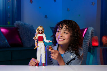 Child playing with the Disney Zombies 4 Nova Bright doll wearing sunglasses
