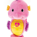 Front view of the pink Soothe & Glow Seahorse with a heart music note on its yellow belly