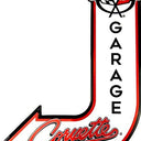 A J-shaped metal sign for Corvette Garage, featuring a white background with a bold red and black border, the Corvette script logo at the bottom pointing left, and the word 'GARAGE' vertically printed in black with a Corvette flag emblem at the top.