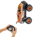 RC Tiger Shark monster truck standing up on its rear wheels, with hands on the remote