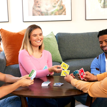 Four players around a coffee table playing UNO Teams in pairs