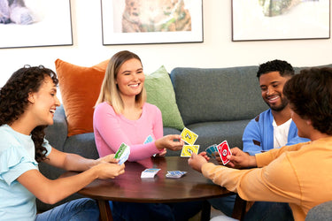 Four players around a coffee table playing UNO Teams in pairs