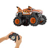 Orange Hot Wheels RC Tiger Shark monster truck with hands holding its remote control