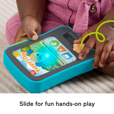 Baby's hand sliding the side activity on the Puppy's Storytime Reader