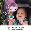 Baby pulling the clacker rings on the Purple Monkey stroller toy