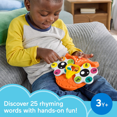 Toddler playing with the Spin 'n Rhyme owl fidget spinner toy