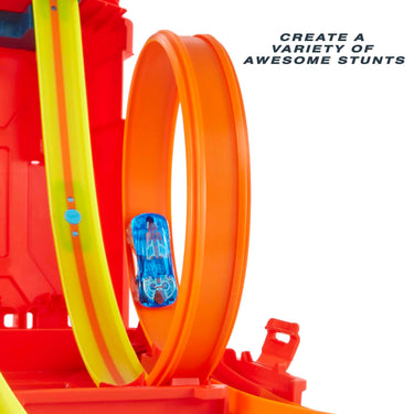 Close-up of a blue Hot Wheels car racing through the orange loop track